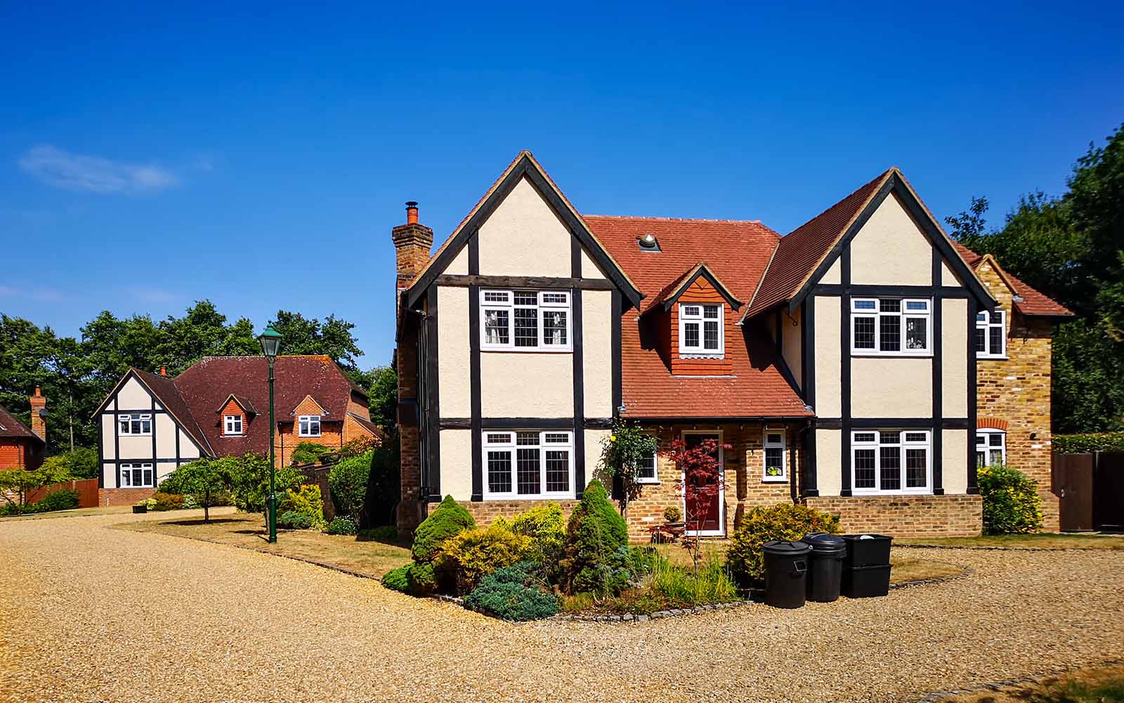 Exterior photo of a New English Estate with beautiful white windows installed by Lomax + Wood