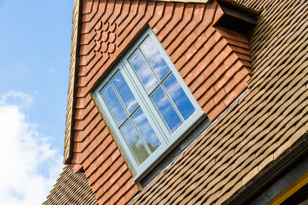 Angled shot of a Grey timber casement window installed on a property by Lomax + Wood 