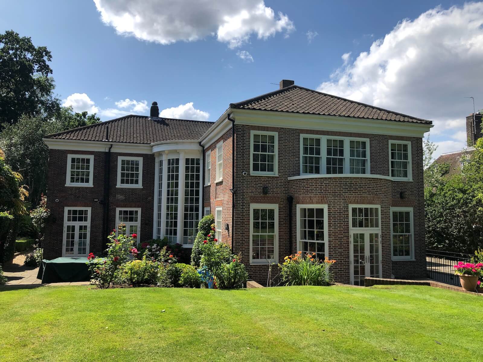 Large mansion home with beautiful white timber single glazed box sash windows 